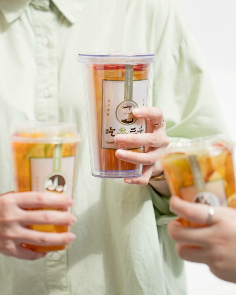 People holding three Chi Cha drinks